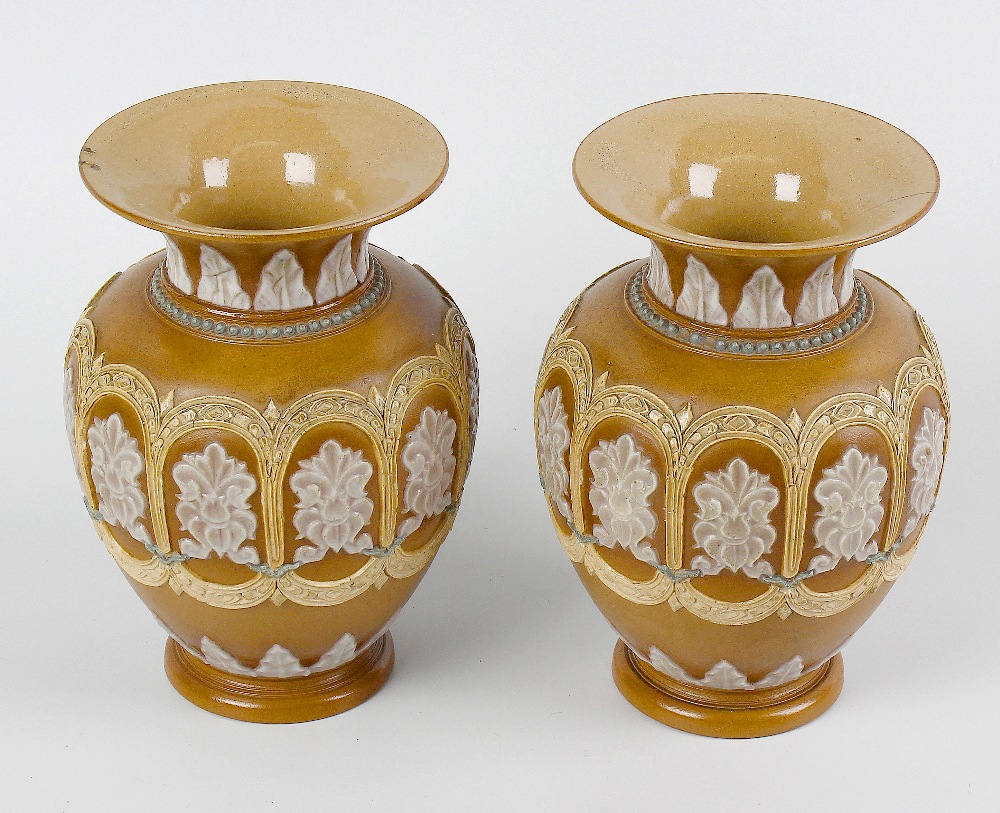 A pair of Doulton Lambeth silicone ware vases. Each of ovoid form with flared neck, having raised