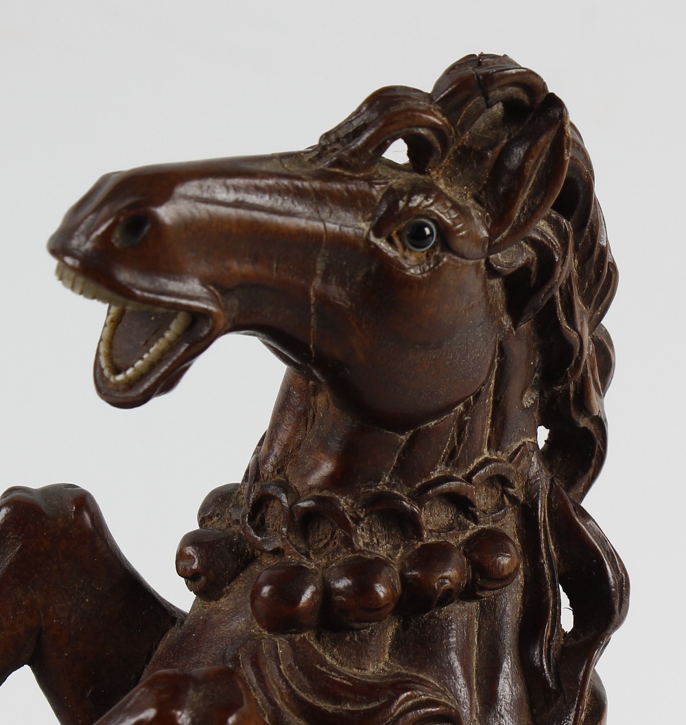 An unusual Oriental carved wooden figure. Modelled as a saddled horse galloping upon a wave, with - Image 2 of 2