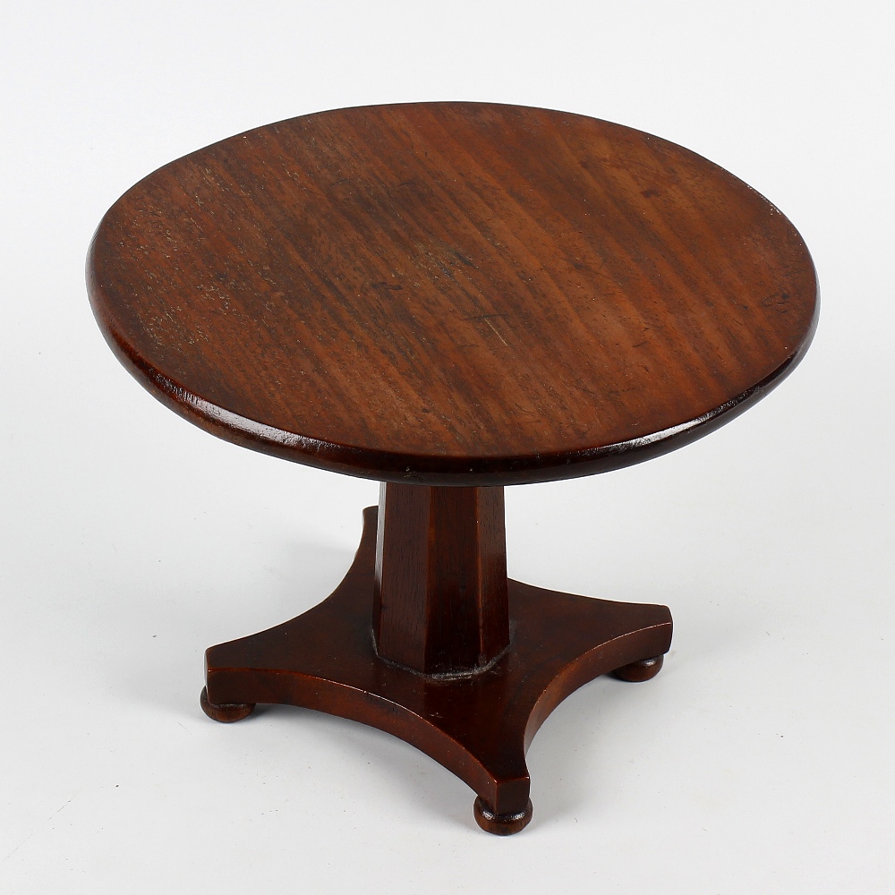 A William IV/early Victorian mahogany miniature centre table. The one-piece circular fixed top on