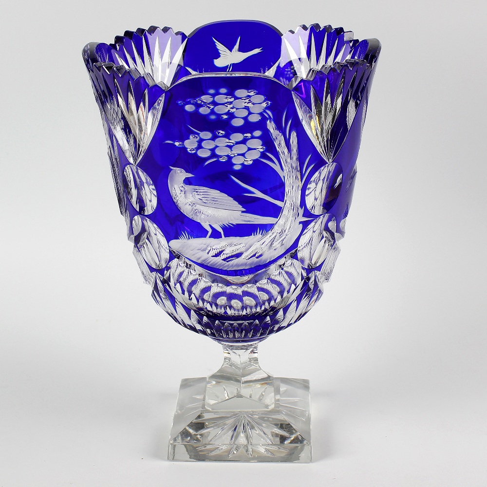 A heavy cut glass vase, the flash cut, blue overlaid glass bowl with frilled collar and bird