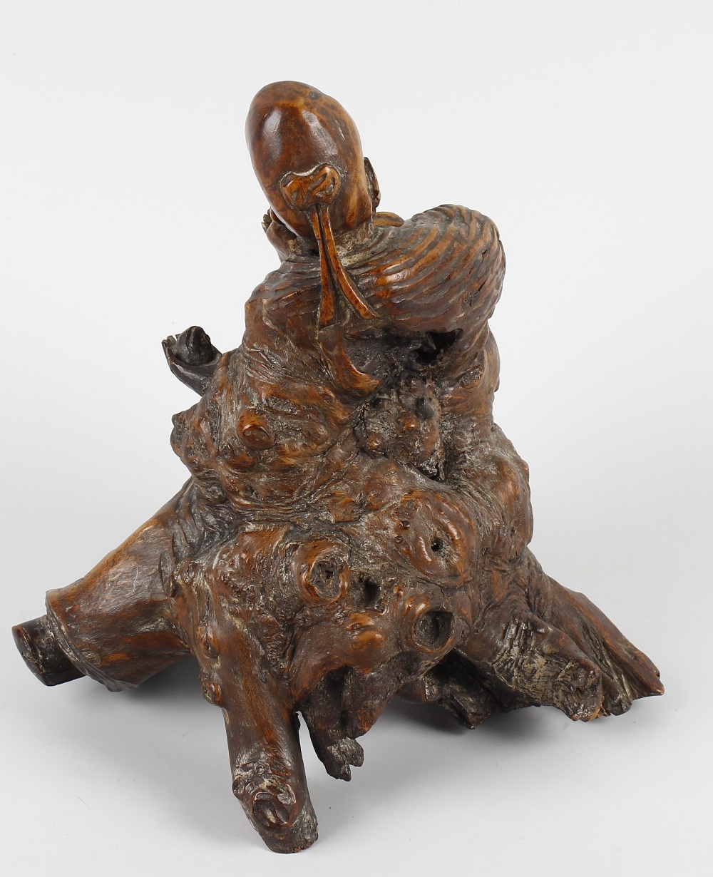 A 19th century Oriental carved rootwood figure. Modelled as a sage or Immortal, holding a peach - Image 2 of 2