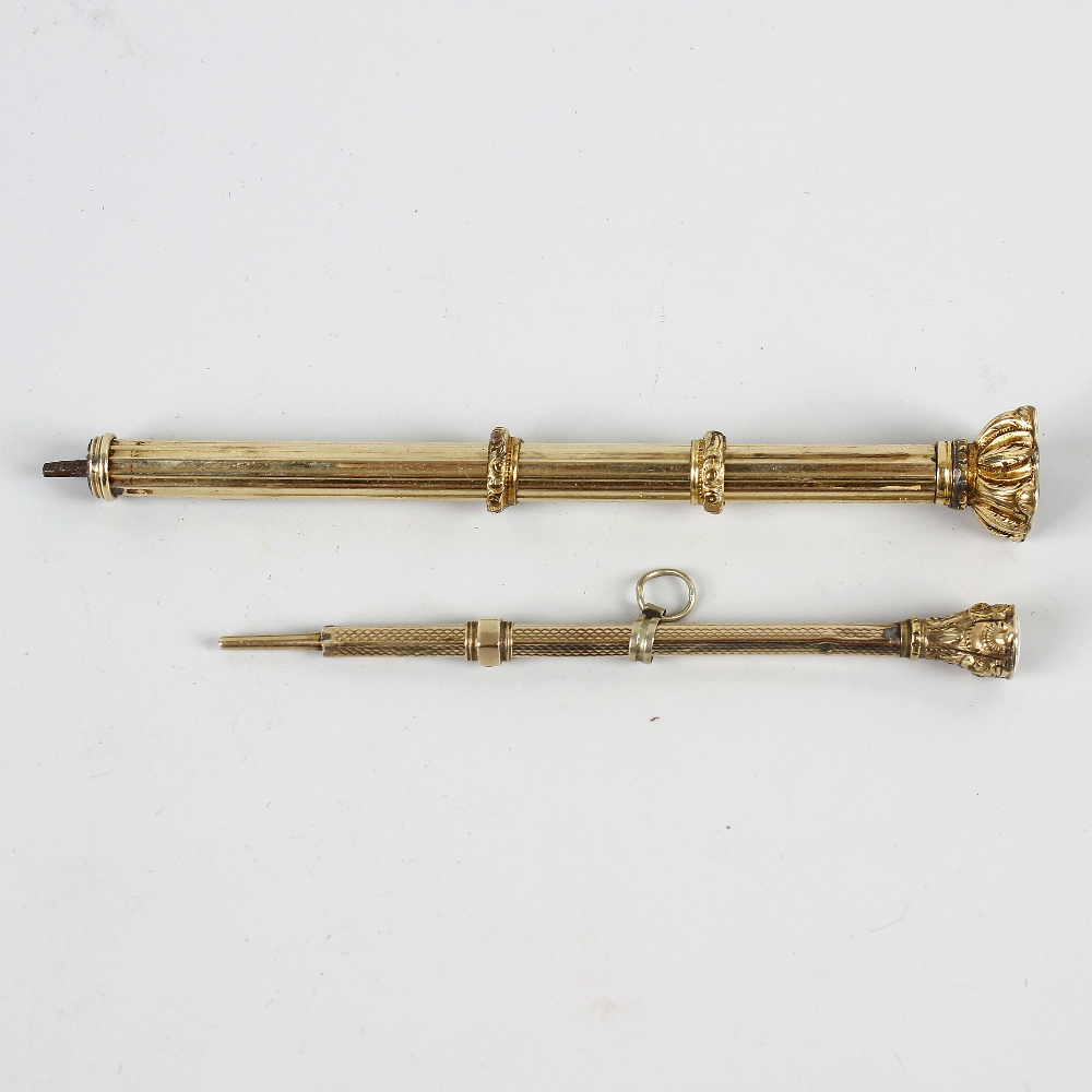 Two 19th century yellow metal propelling pencils. Each of facetted form with stone-set terminal,