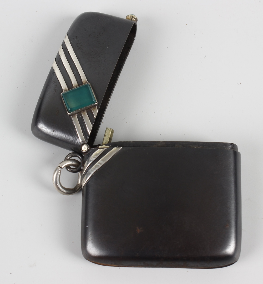 An Art Deco decorated gun-metal vesta case. Of oblong form and shaped for the hip, inset with a - Image 2 of 2