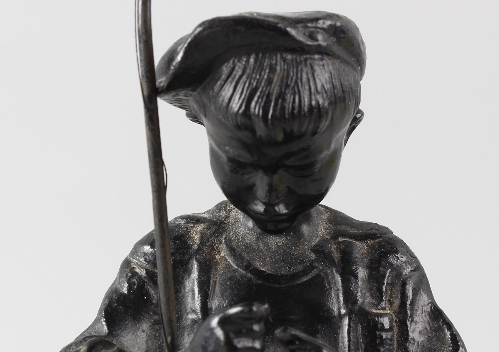 A 20th century Russian iron figure. Modelled as a young fisherboy dressed in rolled up shorts and - Image 2 of 3