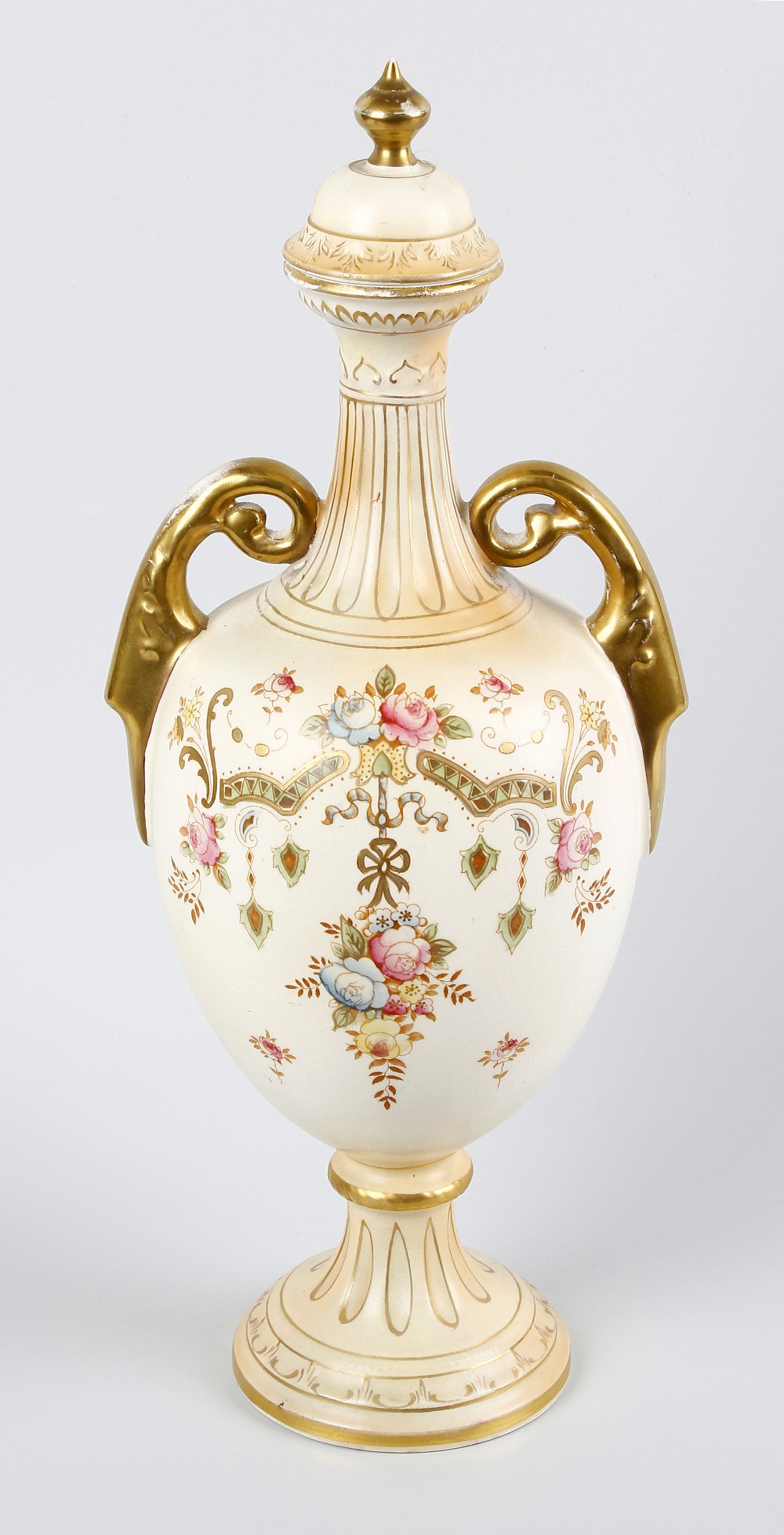 A Crown Devon twin handled vase and cover. Of pear form with slender fluted neck and raised upon a