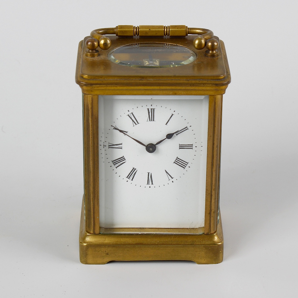 A late 19th century brass cased carriage clock. The 2 inch white dial with black Roman numerals