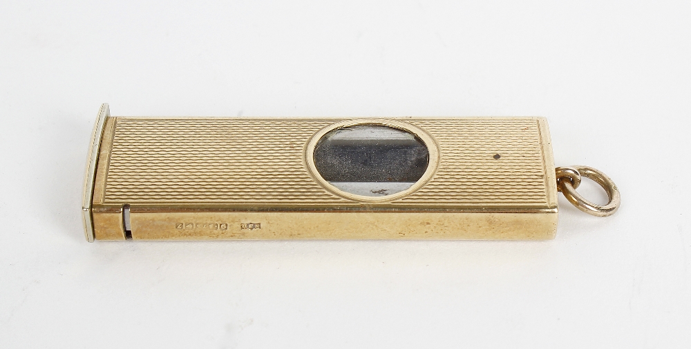 A 1980's 9ct cased cigar cutter. Of rectangular form having textured surface and circular aperture