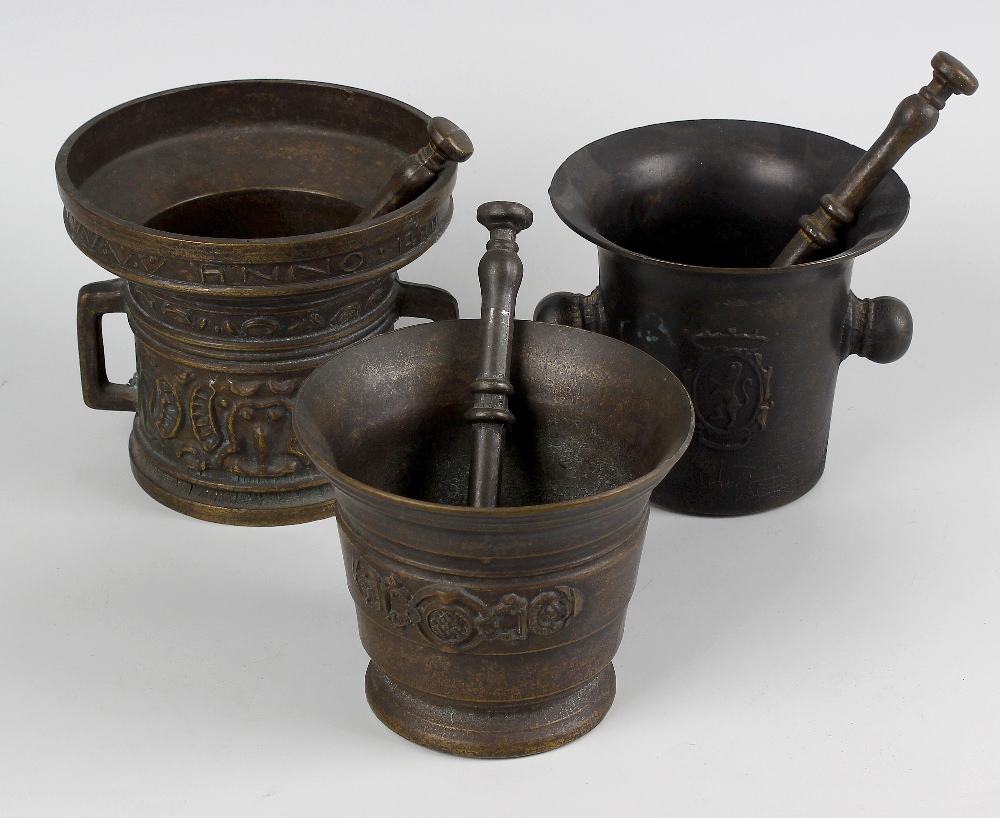 A box containing seven assorted cast mortars with pestles. The largest in 15th century style with