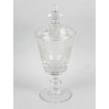 An etched glass pedestal vase and cover. The tapering vase etched with grapevines, raised upon a