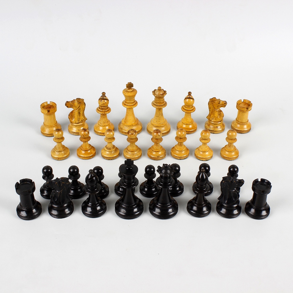 A late 19th century mahogany-cased boxwood and ebony chess set. Of Staunton type, unmarked and