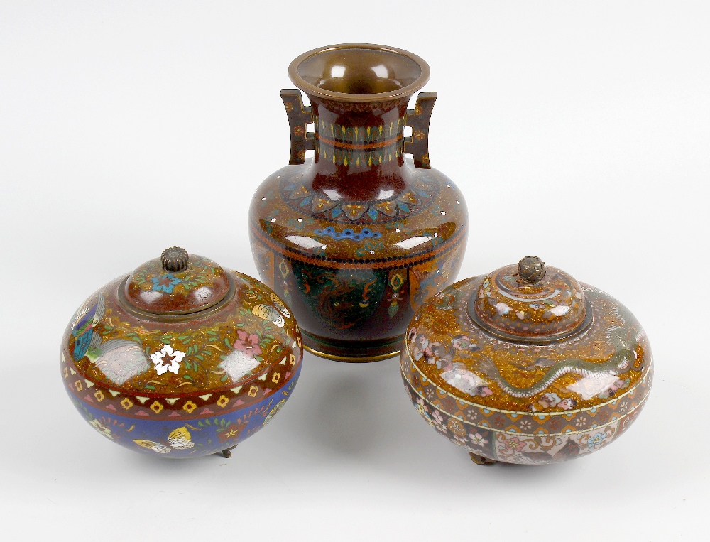 A group of cloisonne wares. Comprising a pair of pots and covers of bulbous form raised upon three