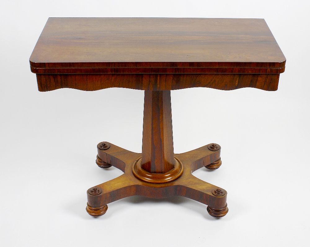 An early Victorian rosewood fold-over pedestal card table. The rounded oblong top enclosing a