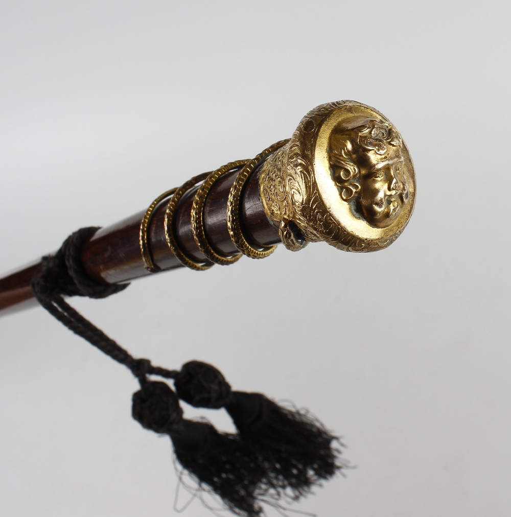 A 19th century gilt metal-topped treen walking stick or cane. The mushroom top with a relief mask - Image 2 of 2