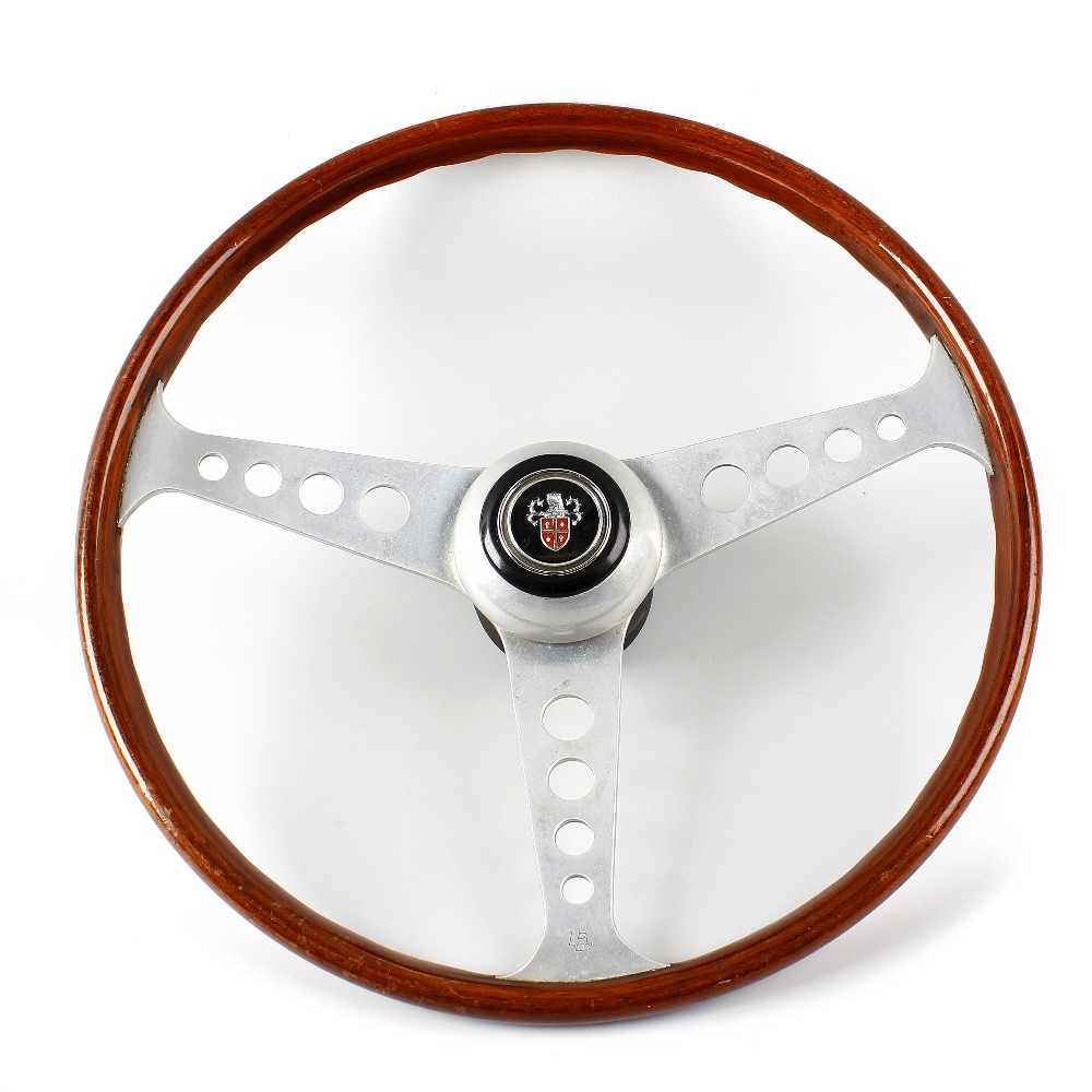 A Les Leston three spoke semi dished wooden rimmed steering wheel. Each of the flat polished