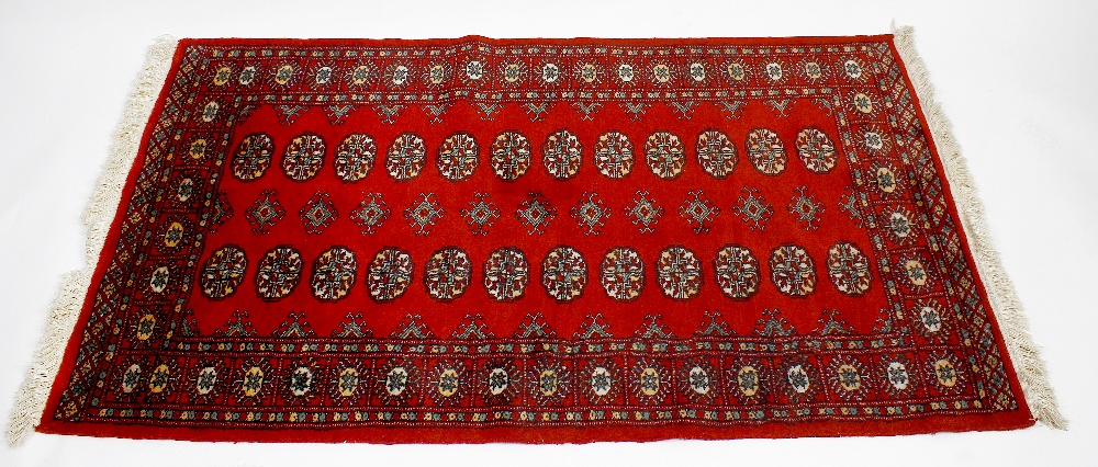 A group of three rugs. Two Belouch or Afghan rugs of similar design having central field of spaced