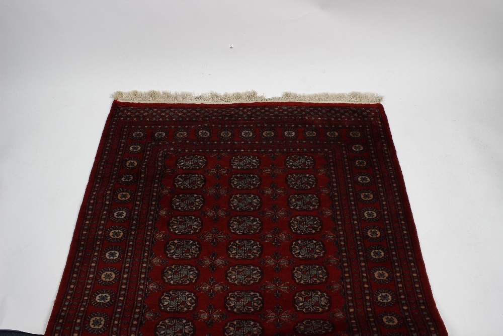 A group of three rugs. Two Belouch or Afghan rugs of similar design having central field of spaced - Image 2 of 3