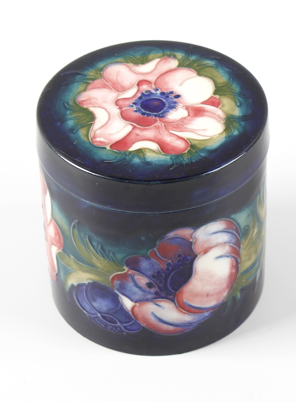 A Moorcroft pottery Anemone pattern jar and cover Of cylindrical form, the flat circular cover and
