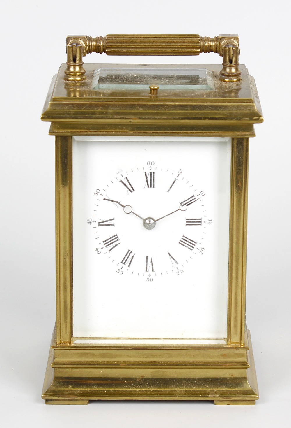 A late 19th century Anglaise-cased brass carriage clock The white dial with Roman hours, Arabic