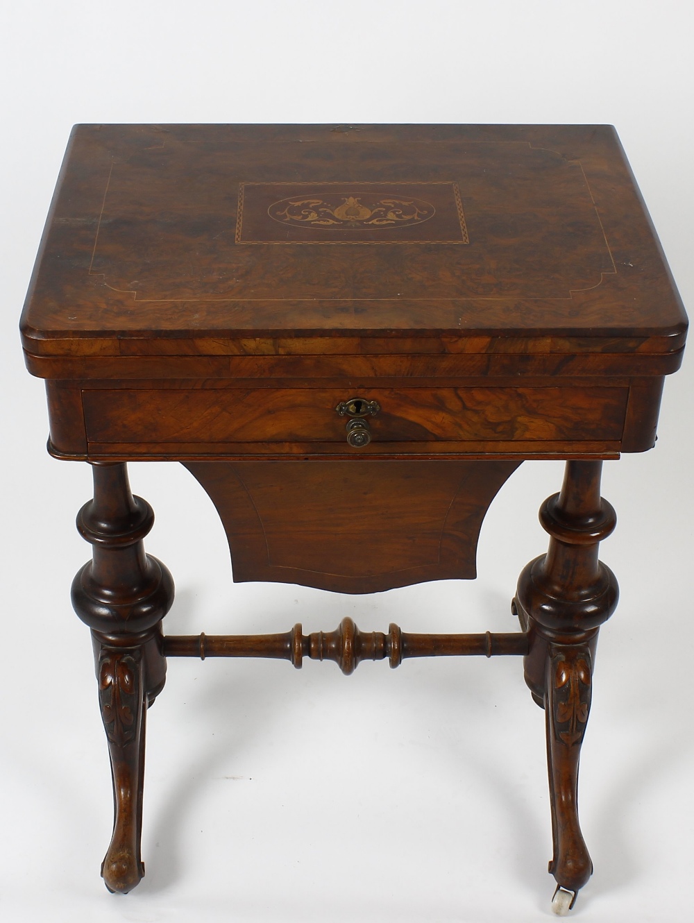 A mid Victorian inlaid walnut fold over games/work table. the figured quarter veneered top with - Image 2 of 4