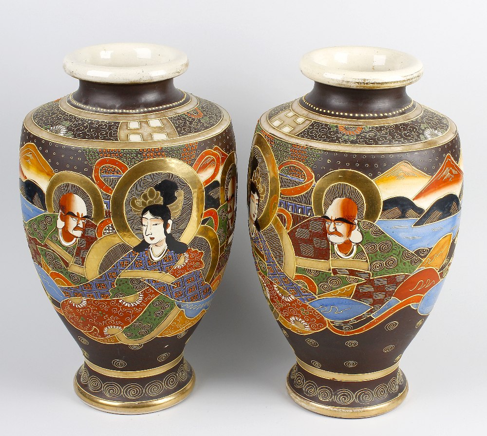 A large pair of 20th century Japanese vases. Of shouldered pear form decorated with figures before a