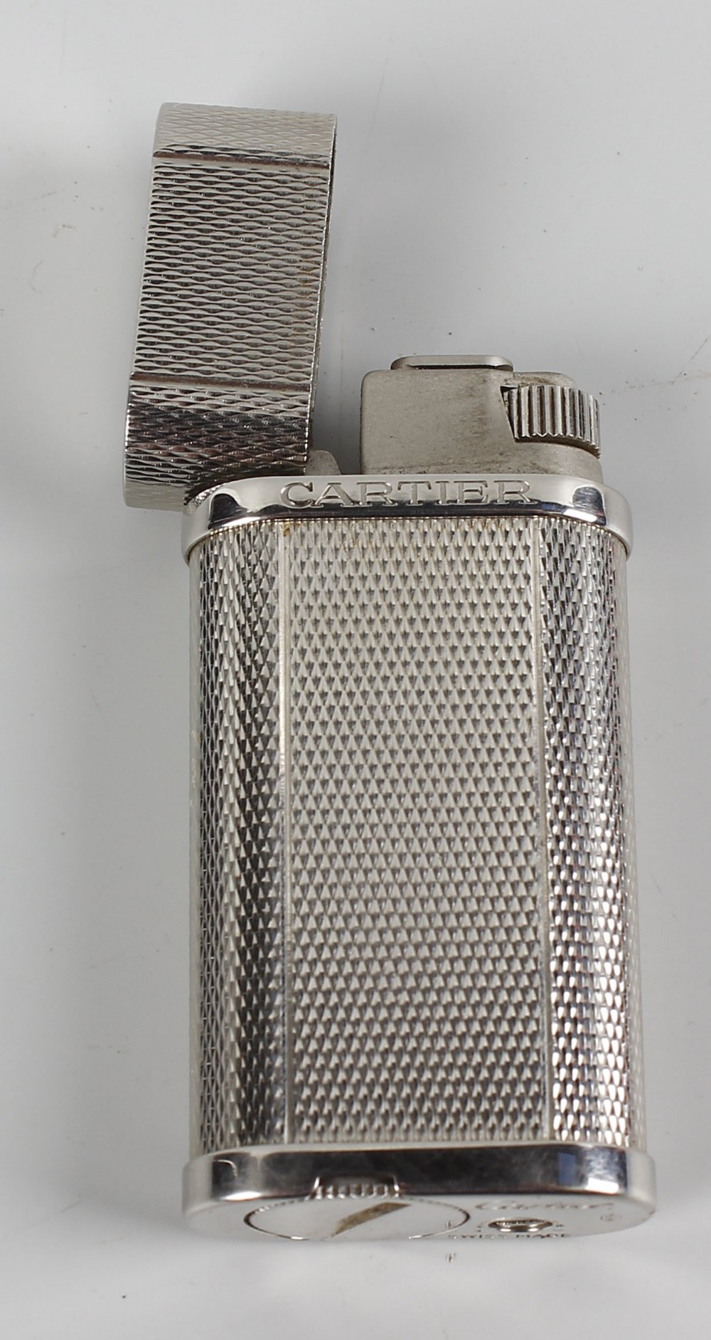 A Cartier silver-plated lighter with textured finish, 2.5 (6cm). Minor wear to body, including - Image 2 of 2