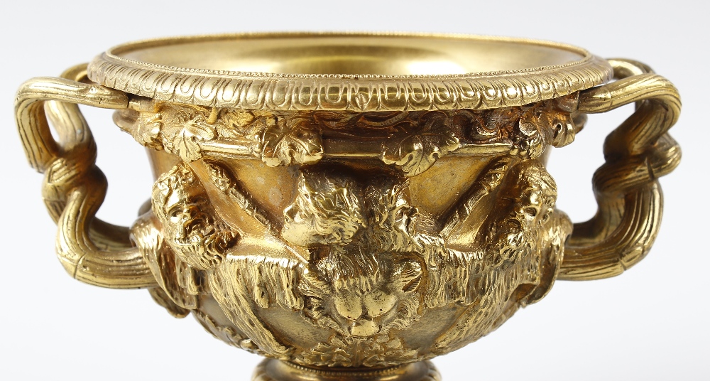 A 19th century small bronze Warwick vase. The relief cast Bacchanalian frieze above formal leaf - Image 2 of 2