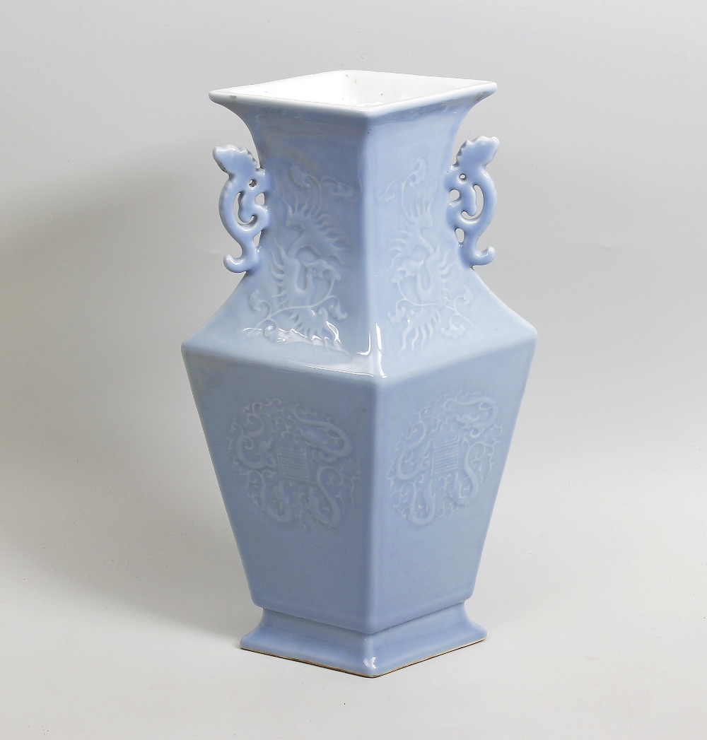 A Chinese porcelain vase. Of lozenge form with waisted neck having applied pierced twin handles,