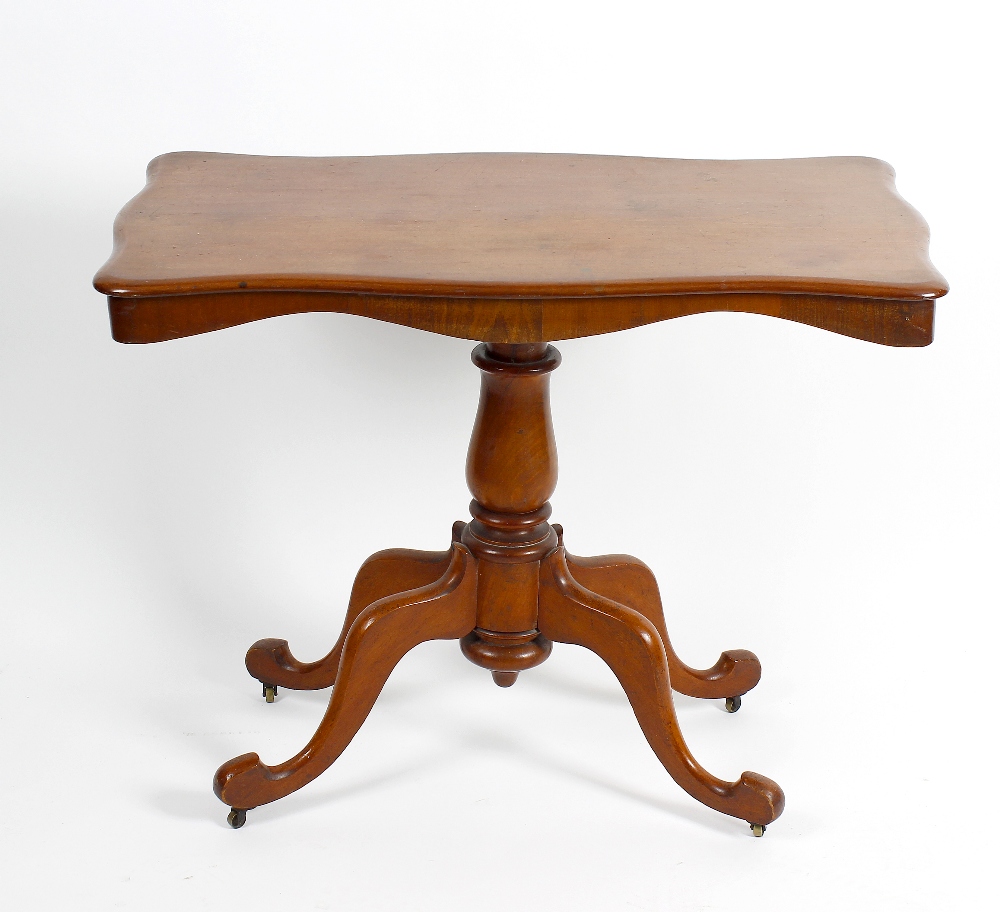 A Victorian mahogany pedestal centre table. The serpentine-sided oblong top on a bulbous stem and