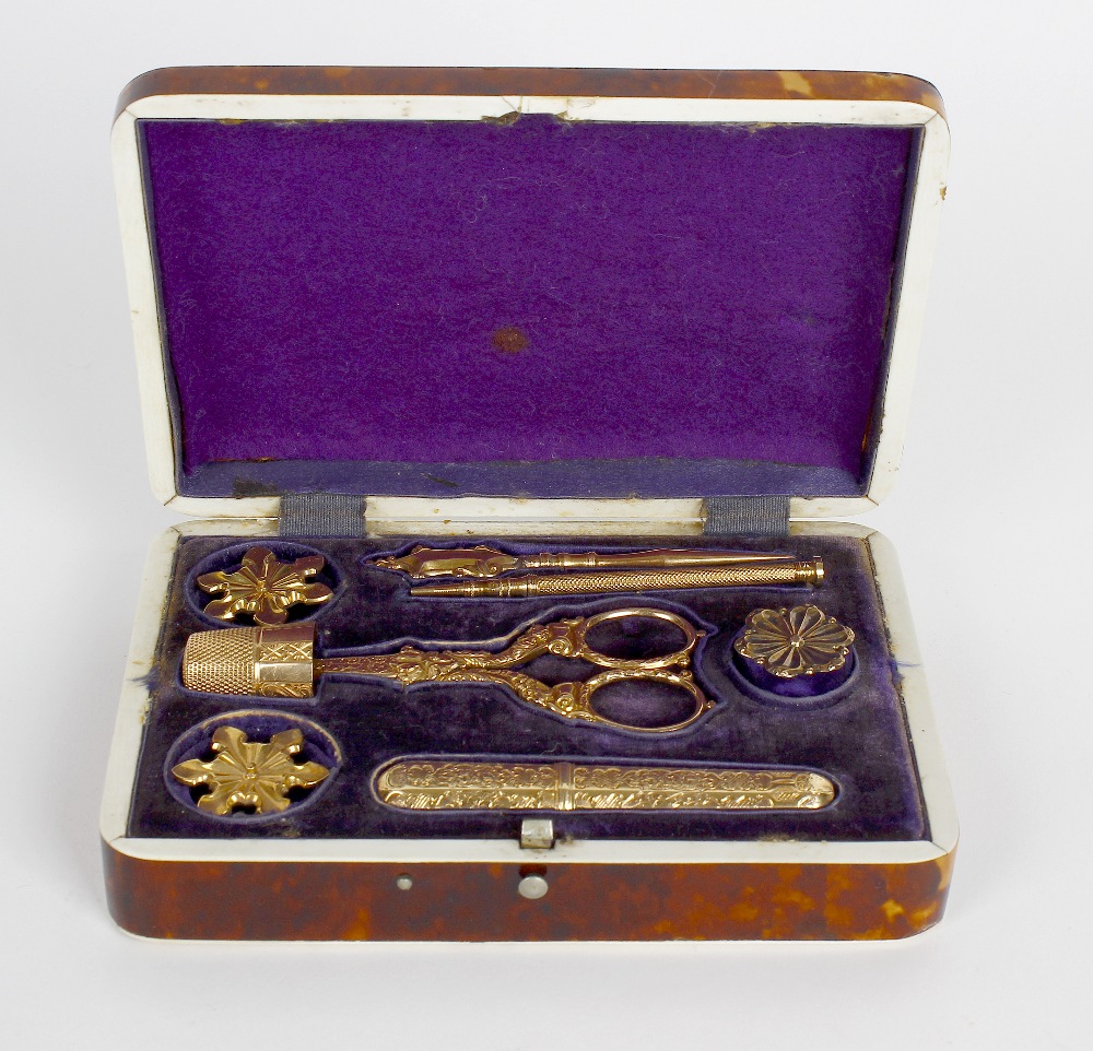 A mid-19th century tortoiseshell and gold necessaire. Of rectangular outline, the hinged cover