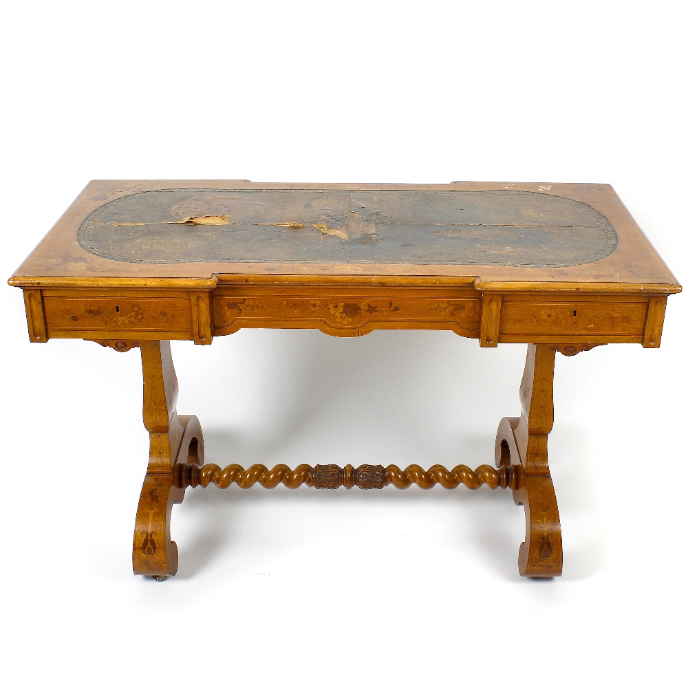 A mid 19th century inlaid satinwood library or centre table. The moulded oblong top with inverted