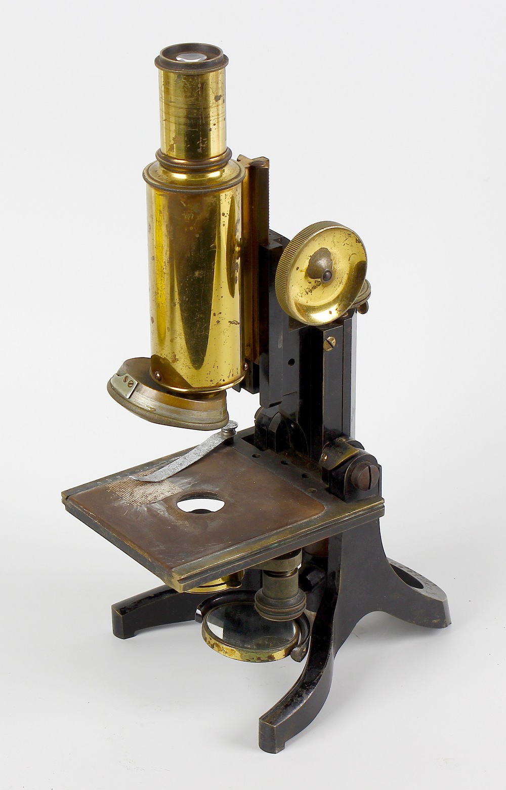 A J. Swift & Son brass microscope. Having rack and pinion coarse and fine adjustment above a
