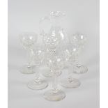 A glass sherry jug plus six glasses. The jug of pear form raised upon circular footed base, and