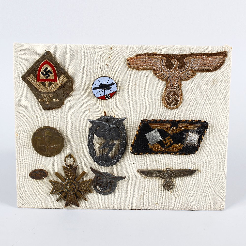 A group of assorted German Third Reich badges. To include fabric and metal examples with eagle and