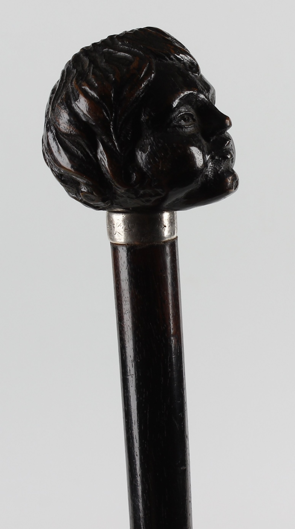 An unusual ebonised walking stick or cane. The handle carved as the head of a child, on engraved - Image 2 of 2