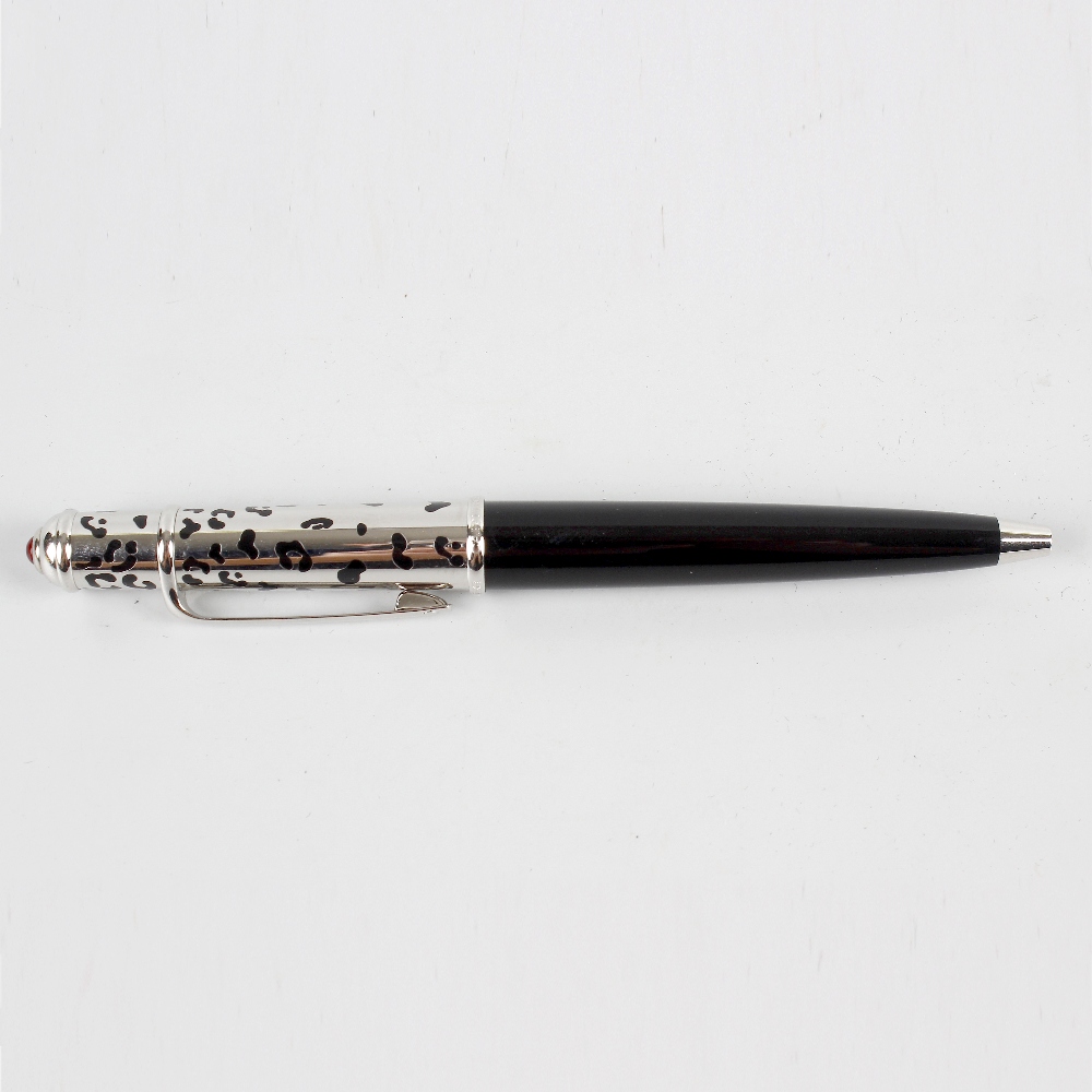 A Cartier ballpoint pen, the black resin lower body with pierced silvered cap, 4.52 (11.5cm) long,