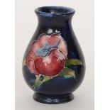 A miniature Moorcroft vase decorated in