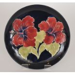 A Moorcroft Pottery Hibiscus pattern pla