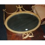 An Edwardian gilt oval wall mirror, the