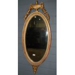 An Edwardian gilt oval wall mirror, the