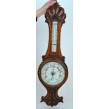 A Victorian carved oak aneroid barometer