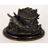 A novelty bronze inkwell, detailed with