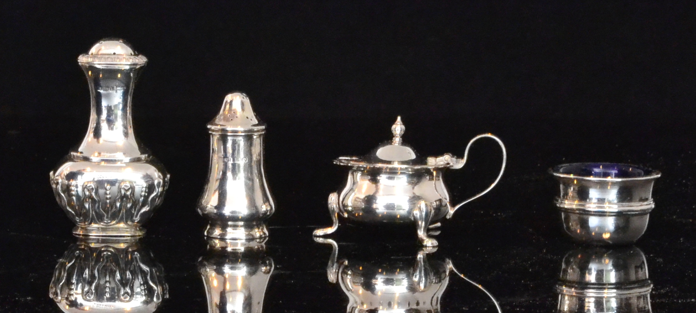 Four associated hallmarked silver condim