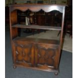 A 1930s oak open bookcase the shaped can