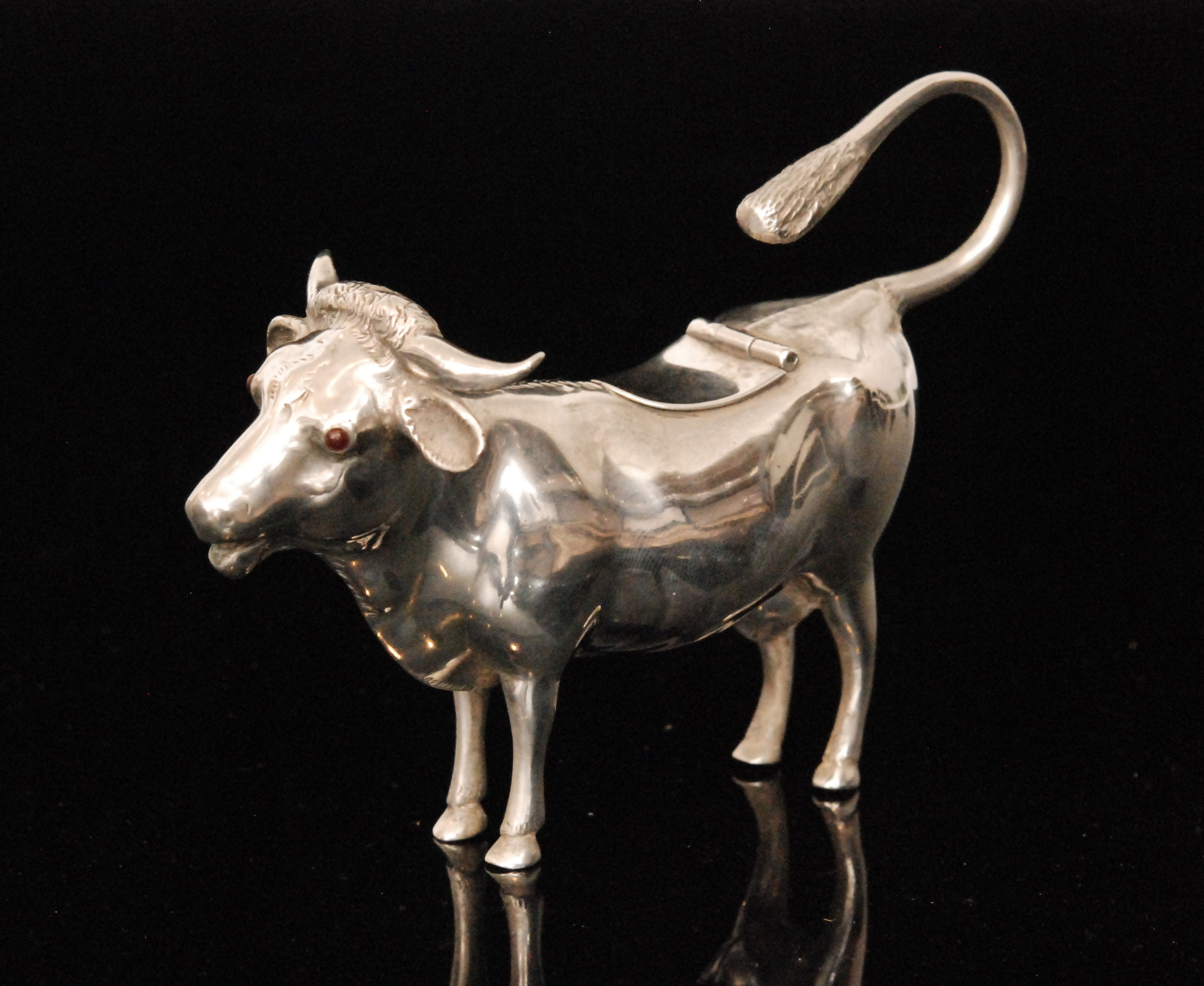 An Edwardian hallmarked silver cow cream