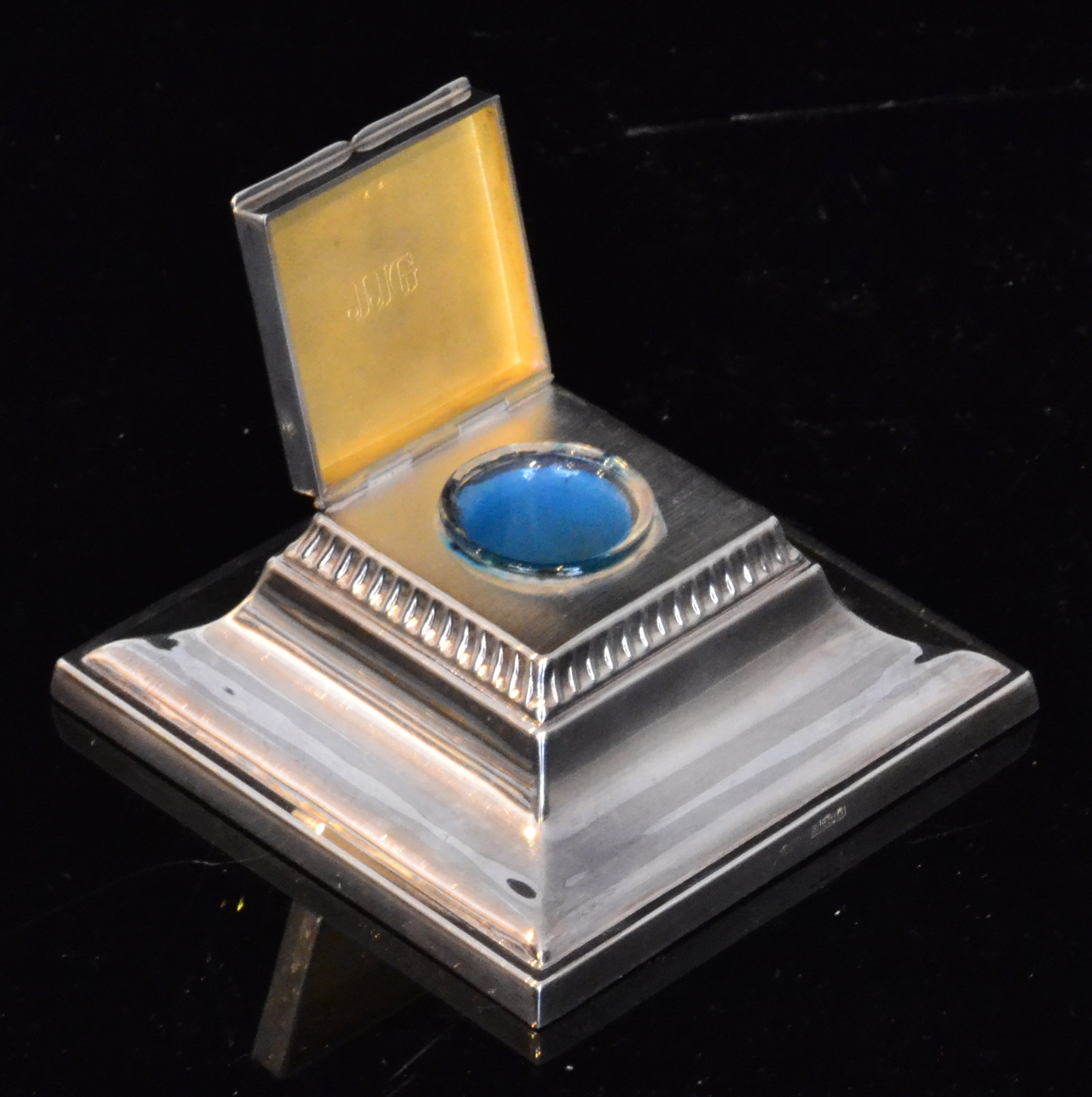 A hallmarked silver inkwell of square fo