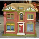 A 1920s painted wooden dolls house, doub