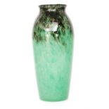 Monart - A 1930s glass vase of slender shouldered form with everted neck cased in clear crystal