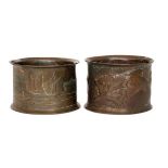 In the manner of Newlyn - Two early 20th Century copper napkin rings, the first with two opened