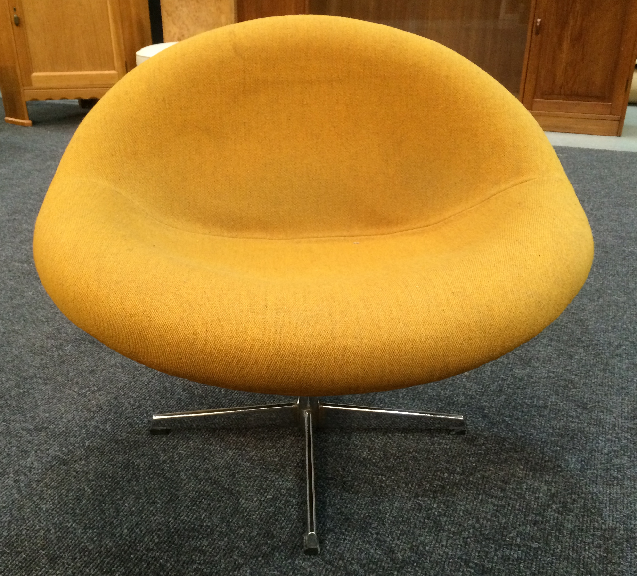 Heals - A 'Juliet' swivel chair, upholstered in a mustard coloured hopsack cloth over the pedestal