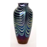 Okra - A studio glass vase of baluster form, the dark blue petrol iridescent ground with silver